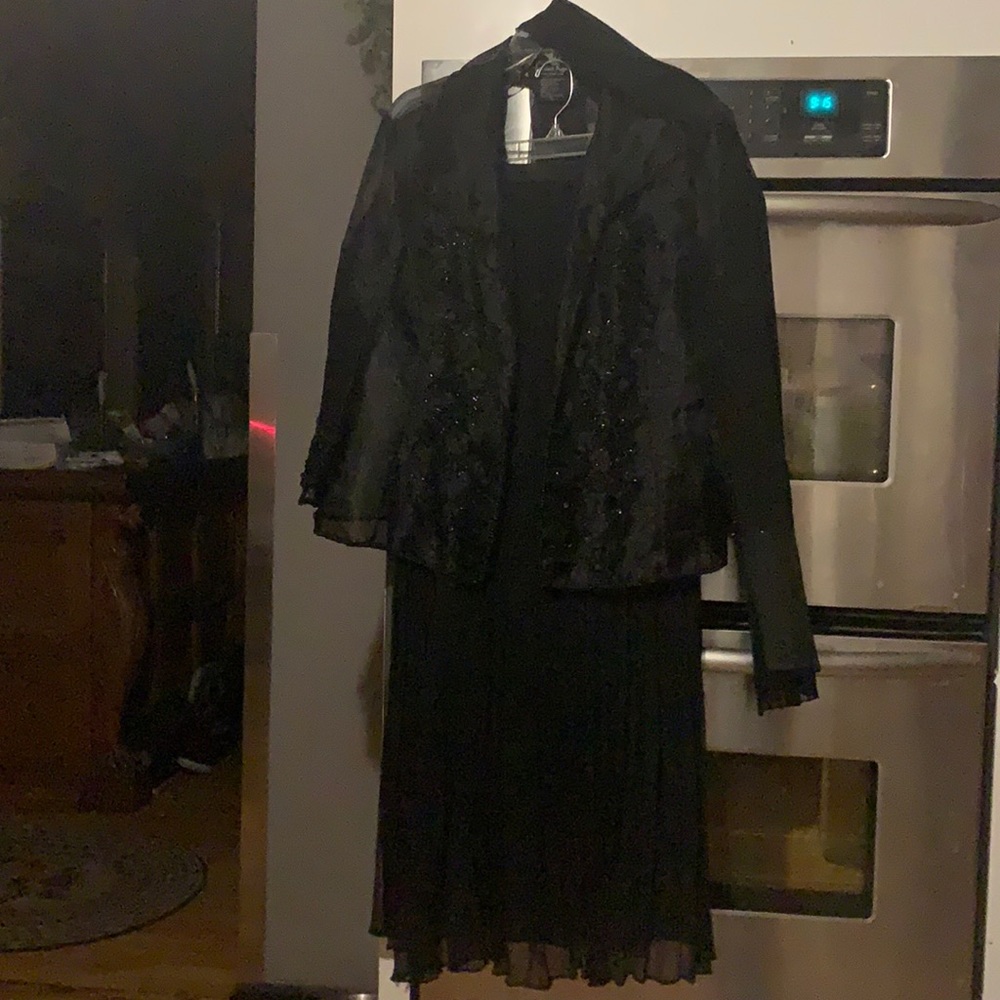 Women’s blazer and skirt combination with scarf.